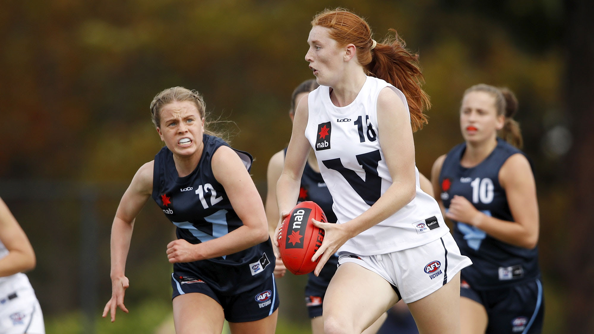 Mackenzie Eardley of Vic Country in action ahead of Mia Busch of Vic Metro during the 2021 AFLW U17 Championships match. Photo: Dylan Burns/AFL Photos/Supplied