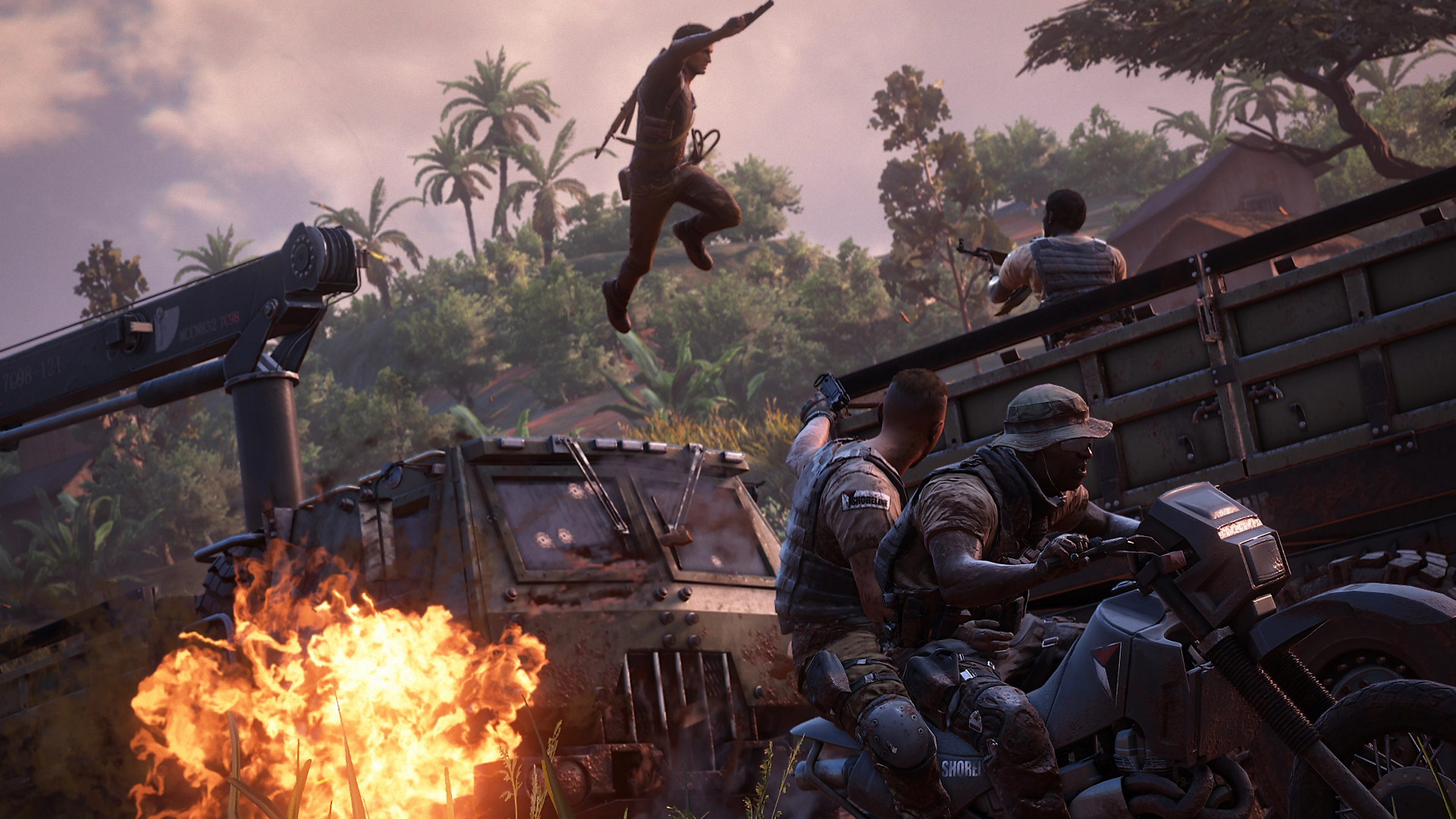 'Uncharted 4' player character Nathan Drake leaps off an armoured van toward an armed enemy amidst an explosion.