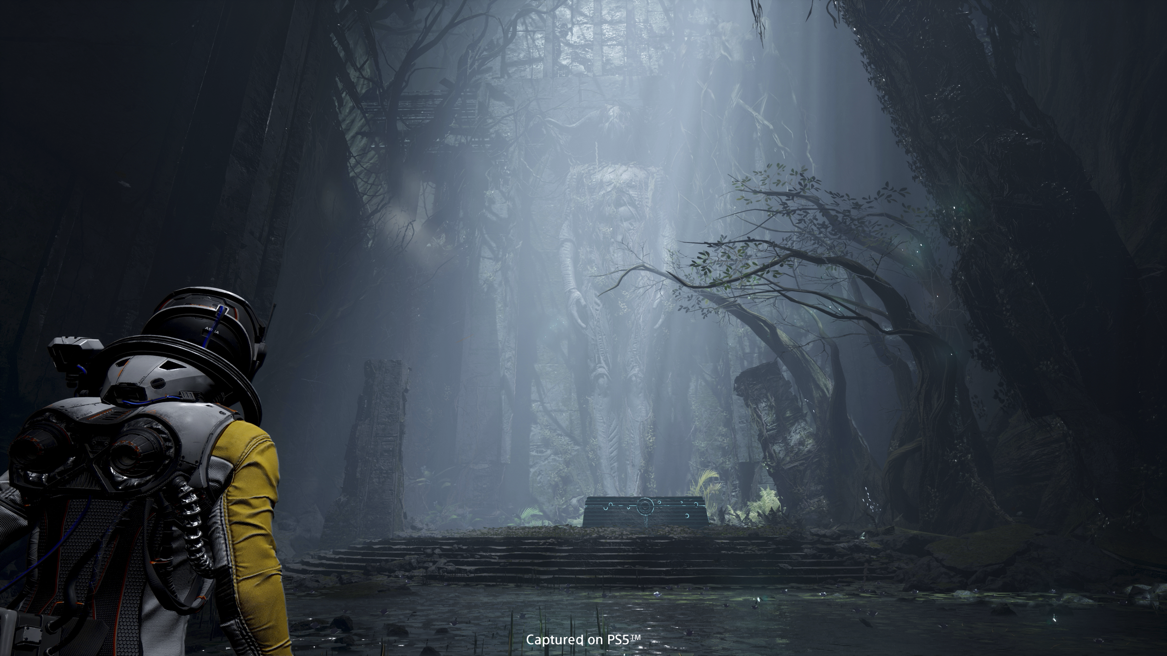 The 'Returnal' player character Silene faces a giant statue imposing upon a forested altar.