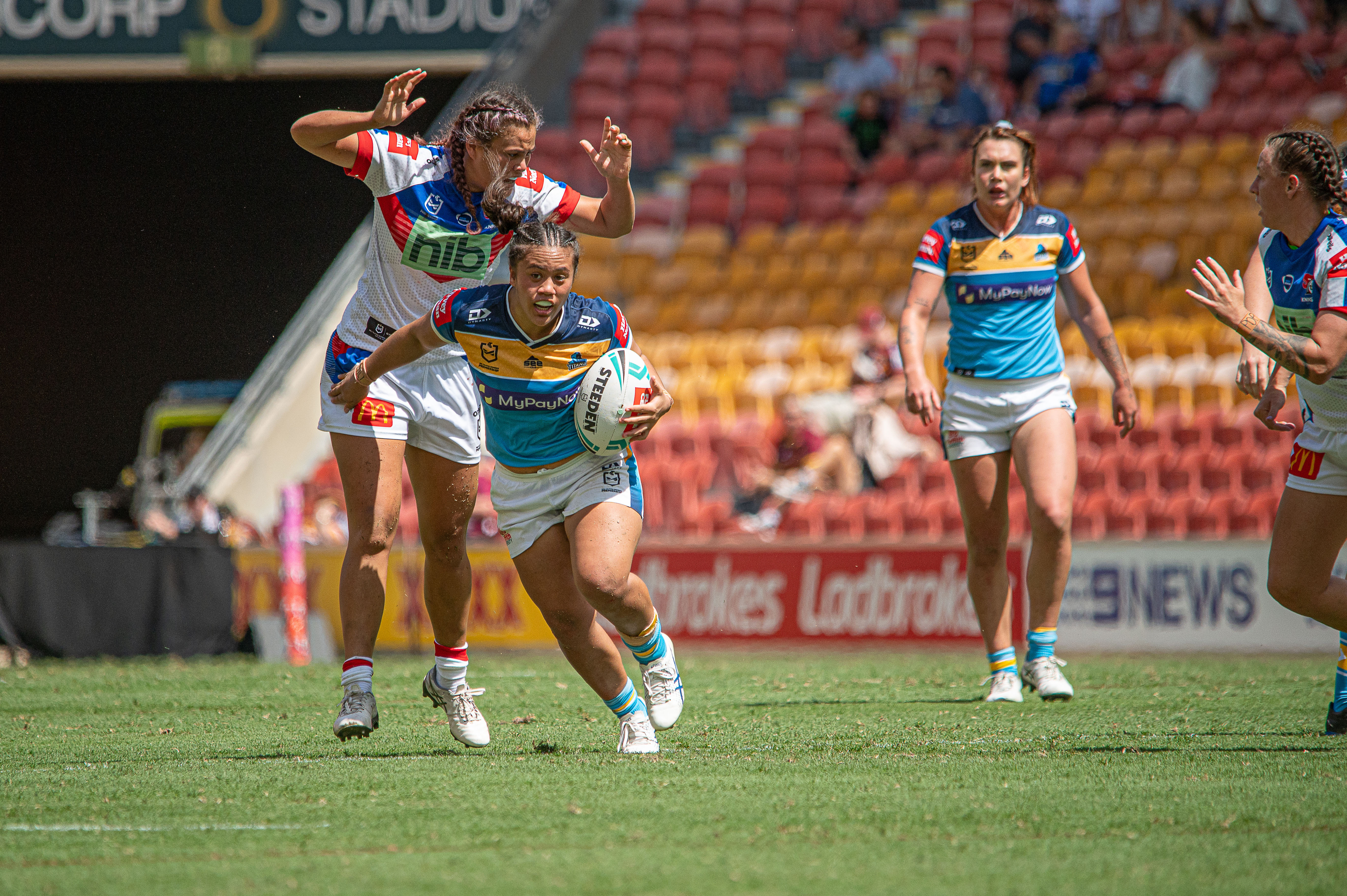 The Titans run the ball in their Round 5 match against the Knights. Photo credit: Nadia Achilles / NJA Photographyadia Achilles / NJA Photography