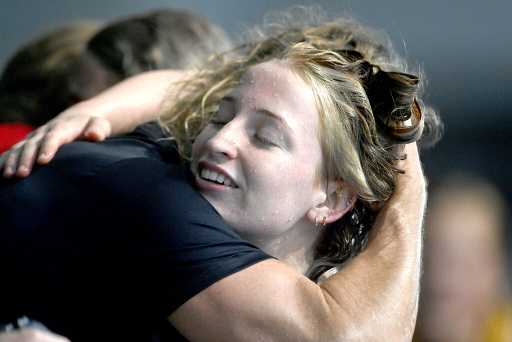 Mollie O'Callaghan embraces coach Dean Boxall on night one of the Australian Swimming Championships.
Photo: Delly Carr/Swimming Australia