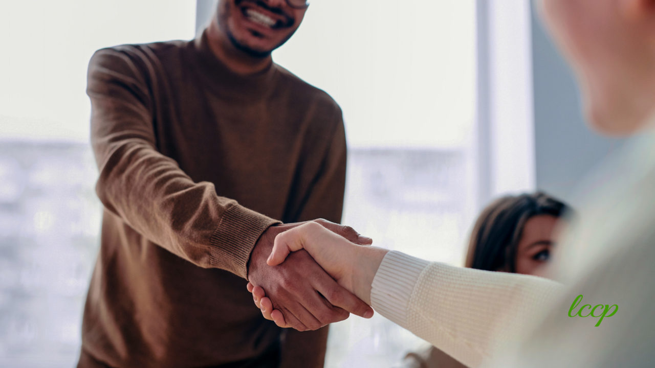 a life coach shaking a client's hand signifying a professional relationship with healthy boundaries. 