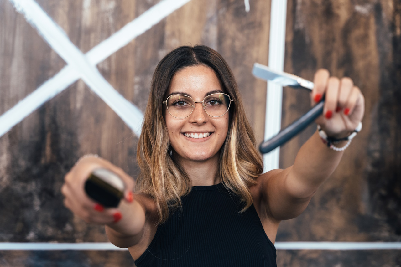 Hairdresser holding electric and manual shavers