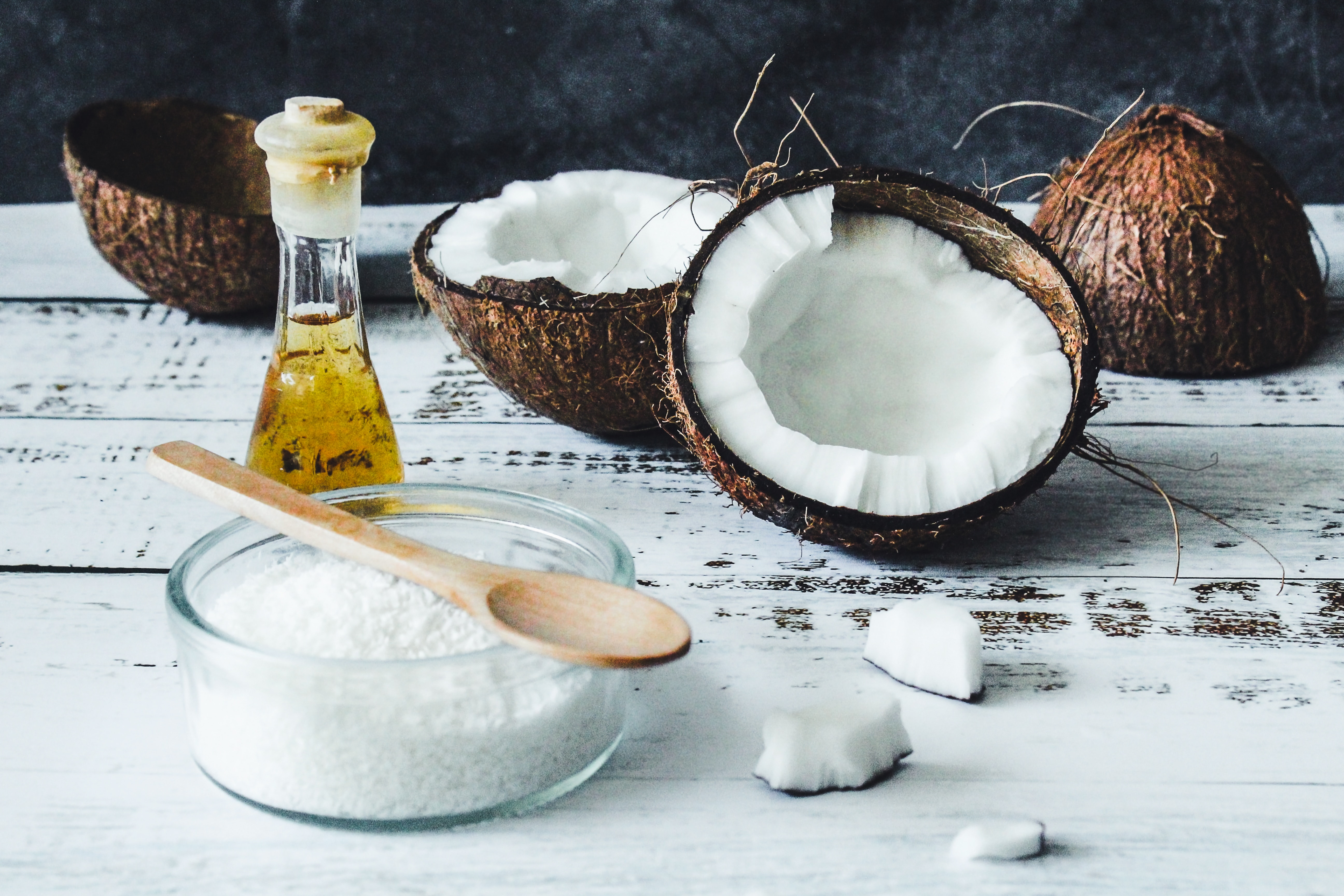 Opened coconut husks showing coconut meat in preparation to make coconut oil