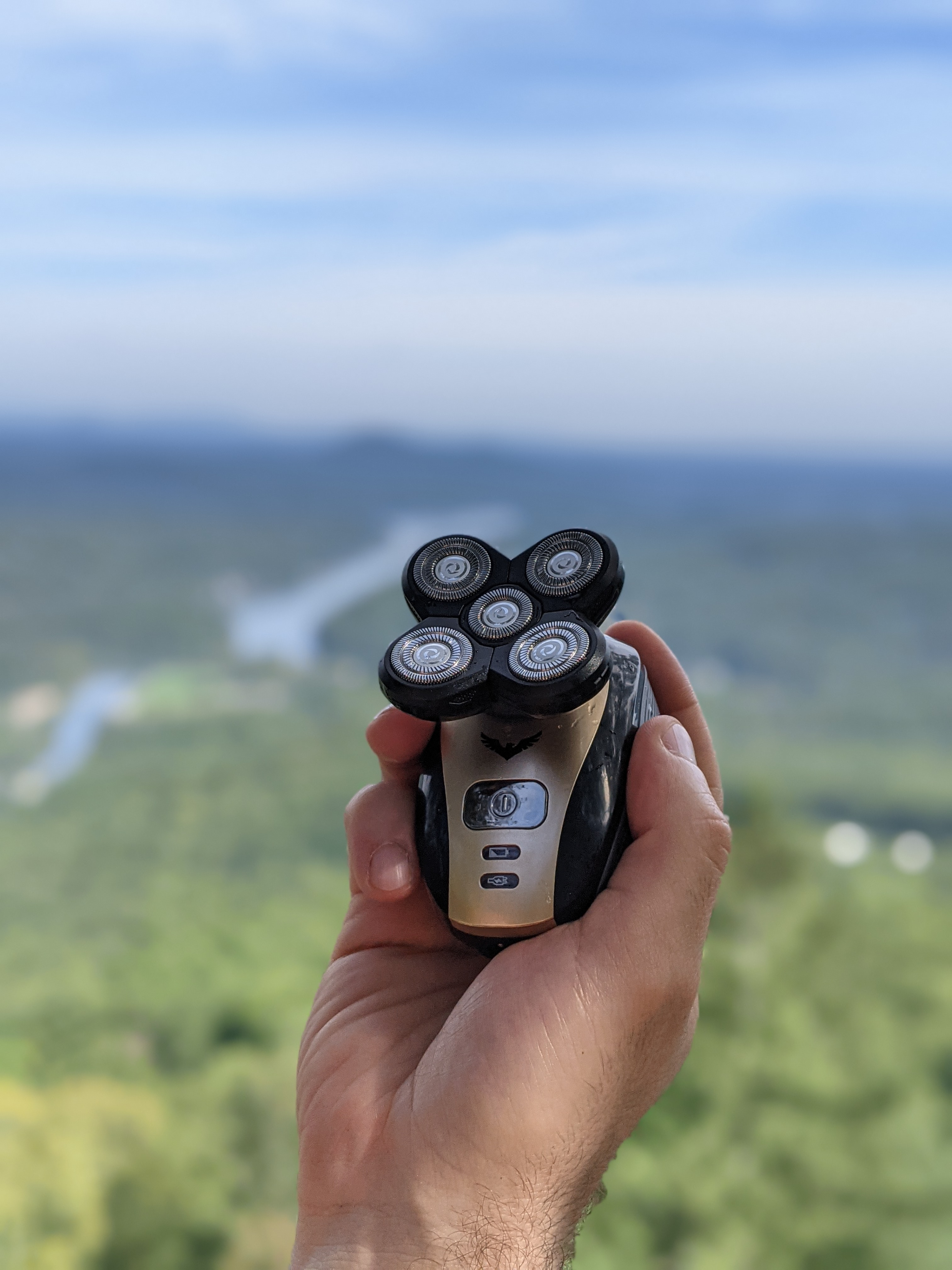 A hand holding the Freebird FlexSeries with the background of the outdoors