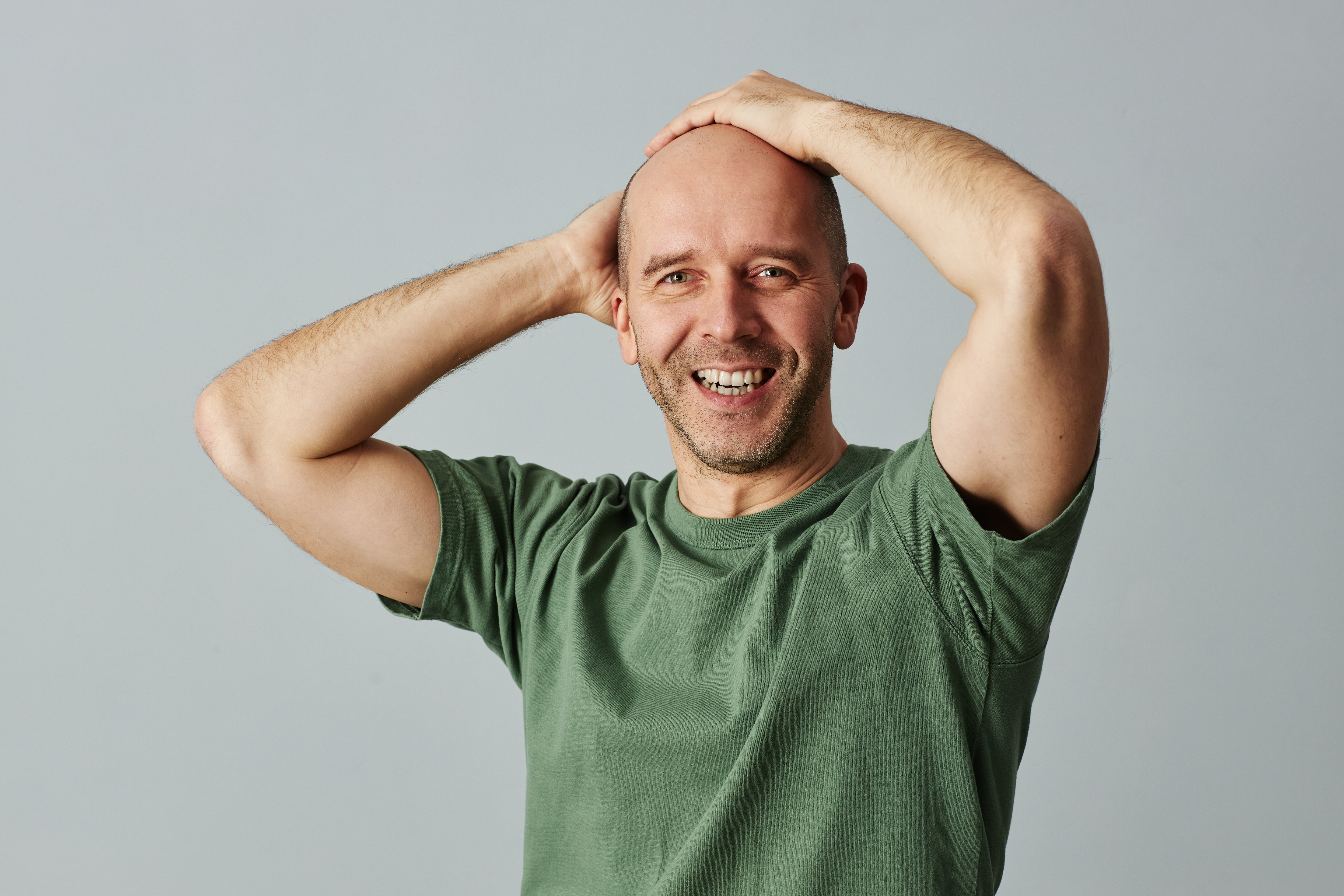 bald man smiling feeling good