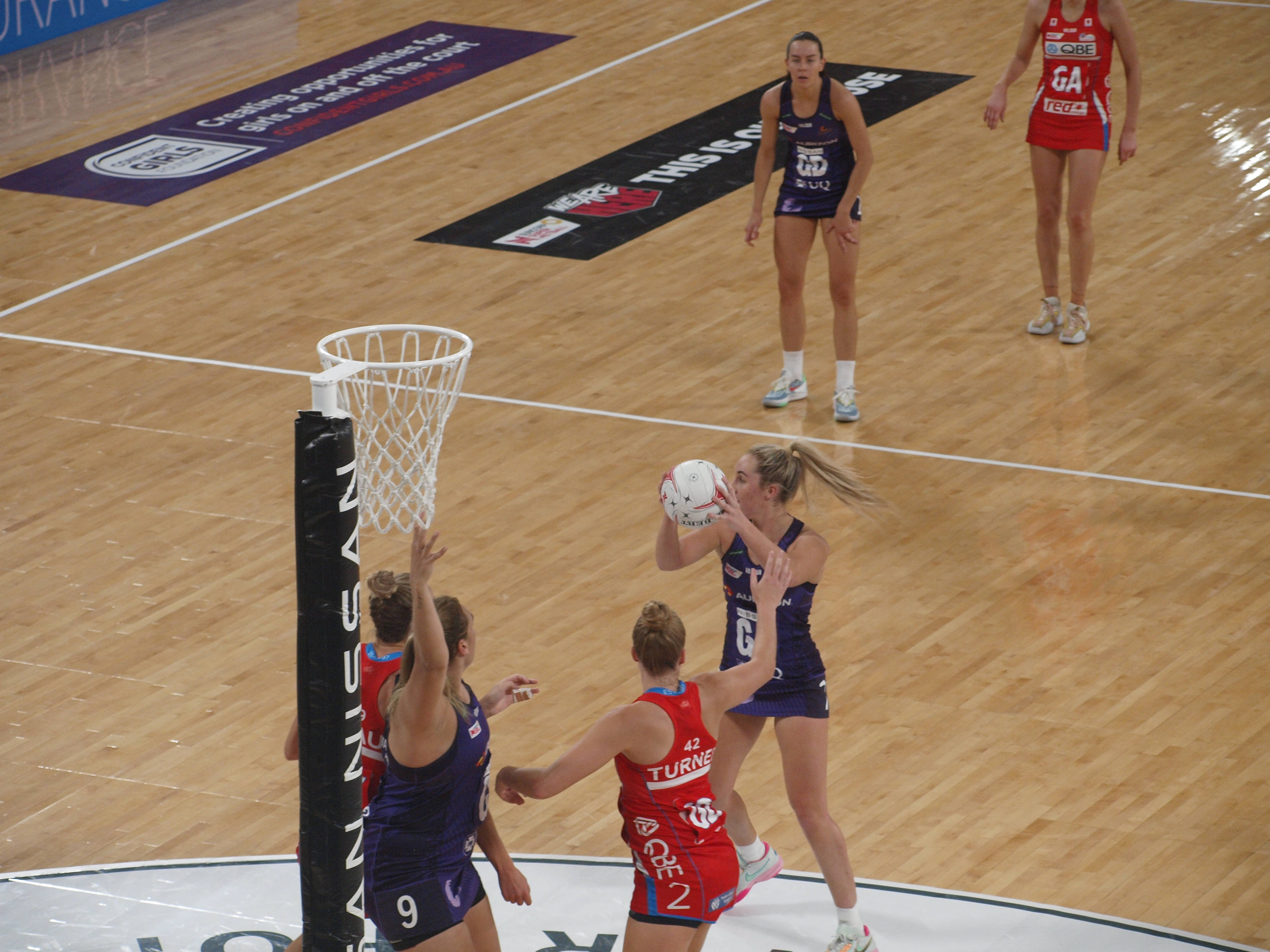 Maddy Turner and Sarah Klau hedge between contesting the rebound against Donnell Wallam and defending Mia Stower's shot. Image: Dan Coppel