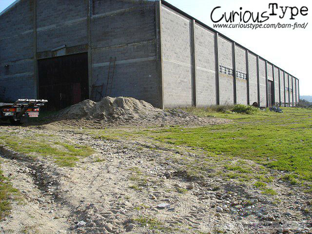 Barn find in Portugal: Vintage car discovered outside a cinder block barn.