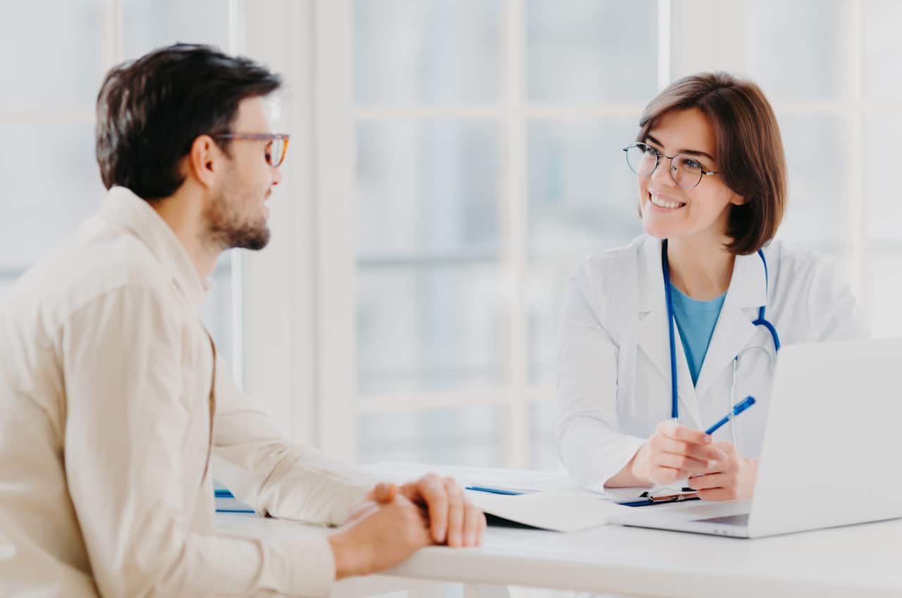 A healthcare professional talking to a patient.