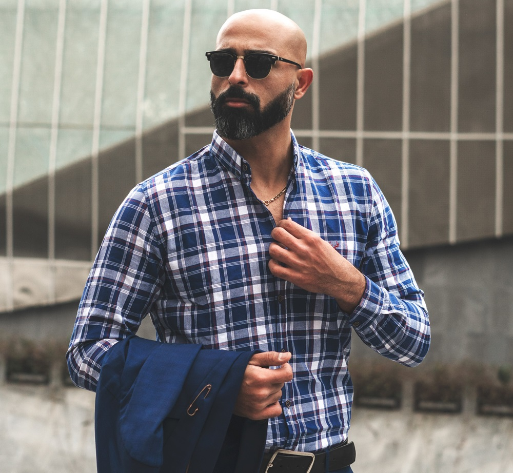 bald and bearded bald man wearing sunglasses showing off his style with confidence