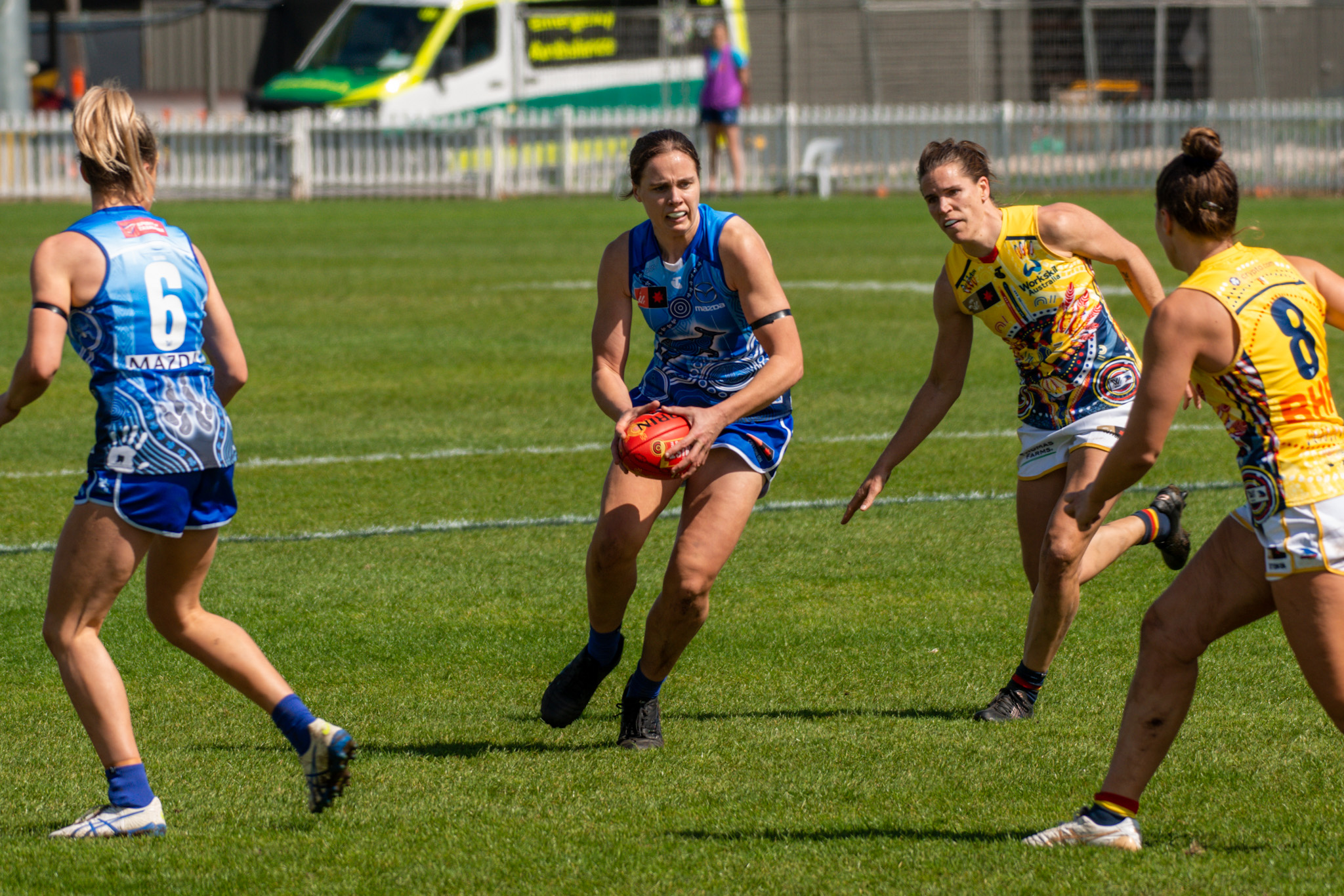 North Melbourne Tasmania's Jasmine Garner looks to advance the ball against the Adelaide defence. Photo: Dani Brown.