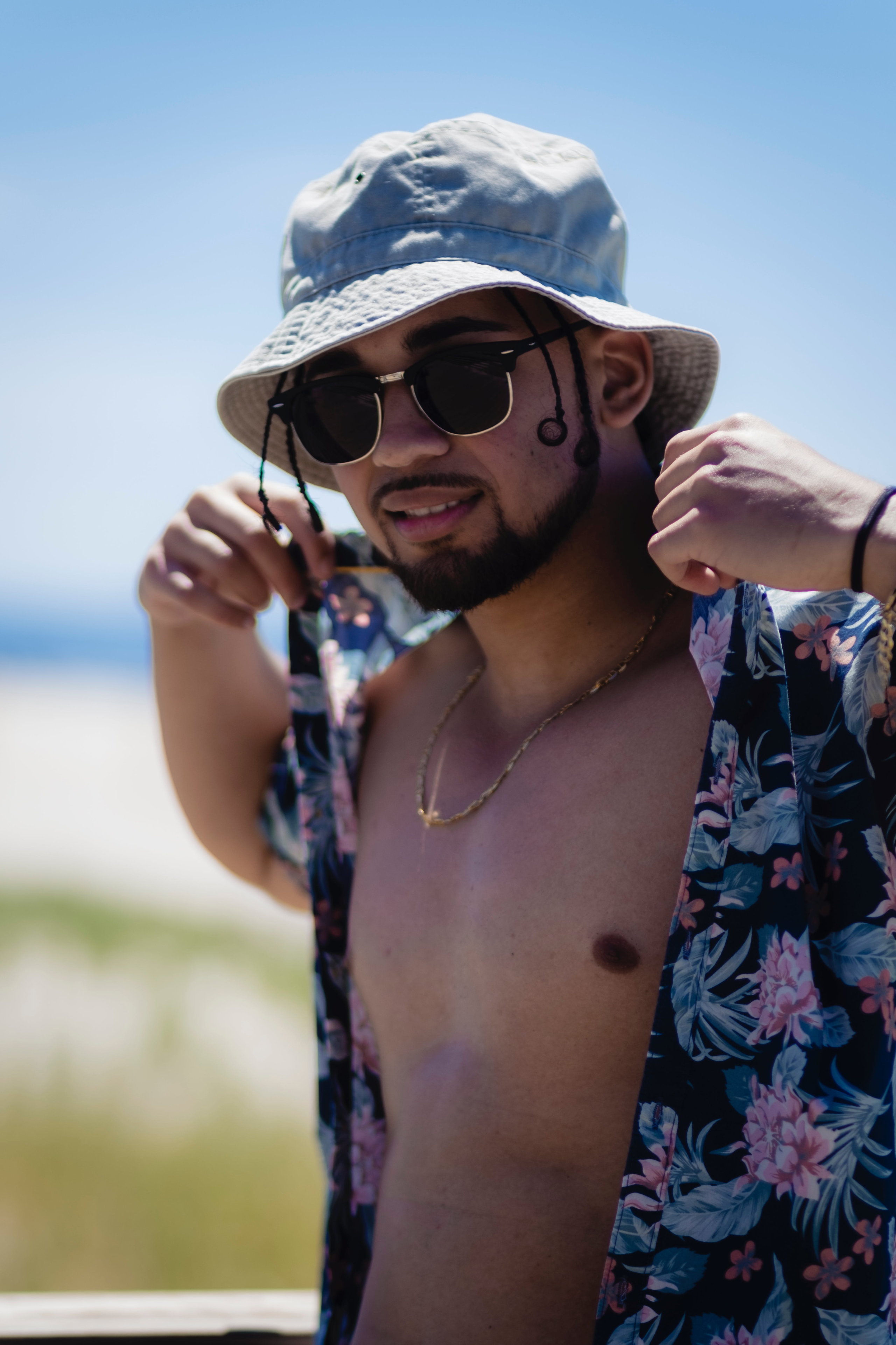 A person wearing a hat outdoors, protecting their head from the sun