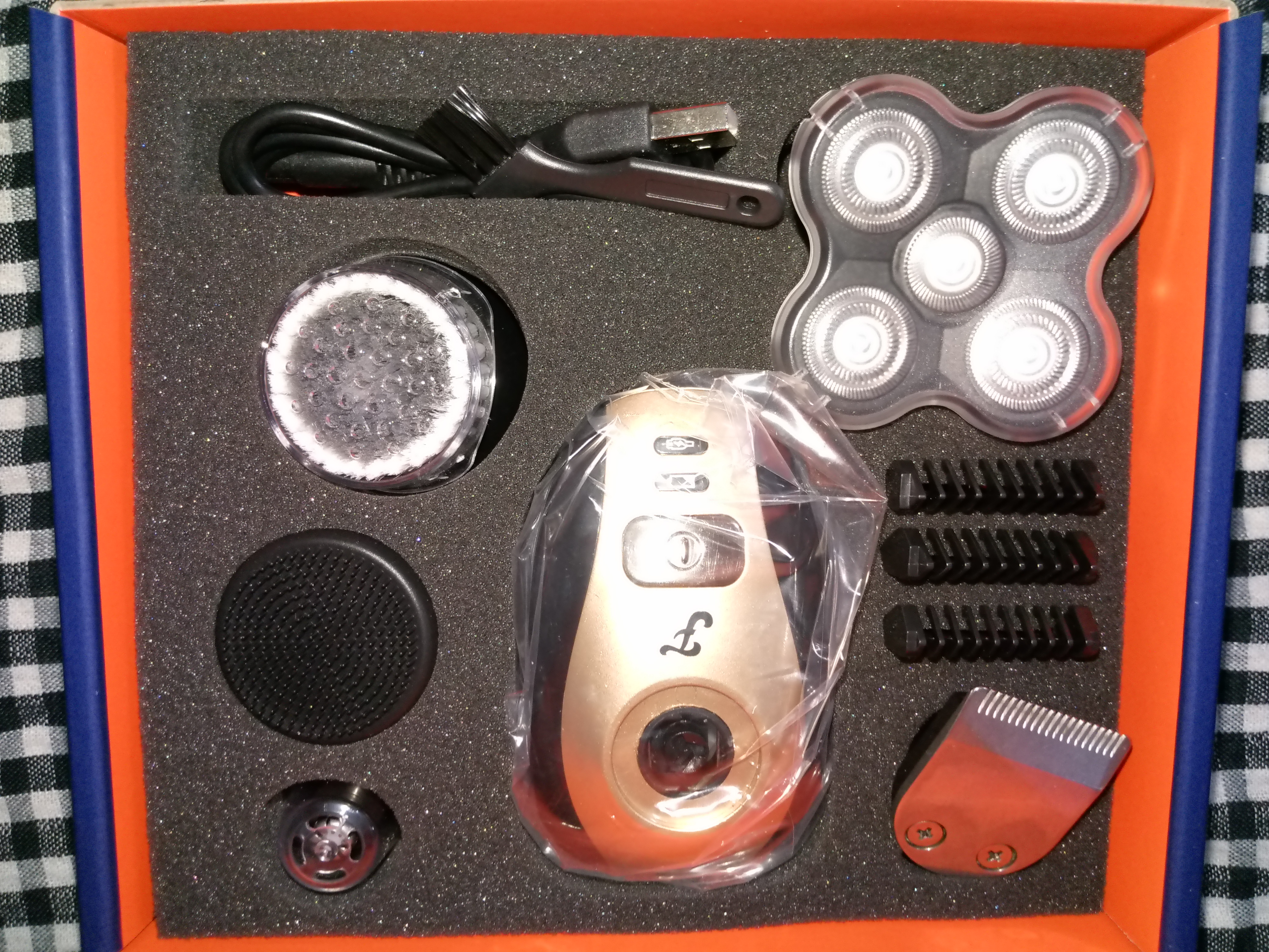 electric shaver blades stored in a box with other attachments and shaver body