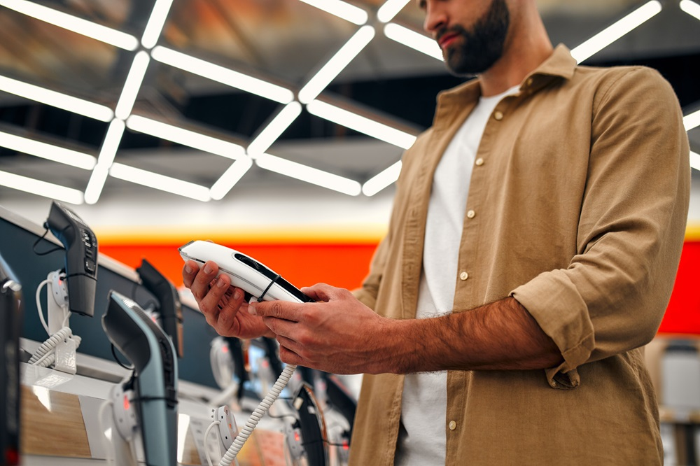 bearded man shopping for an electric shaver