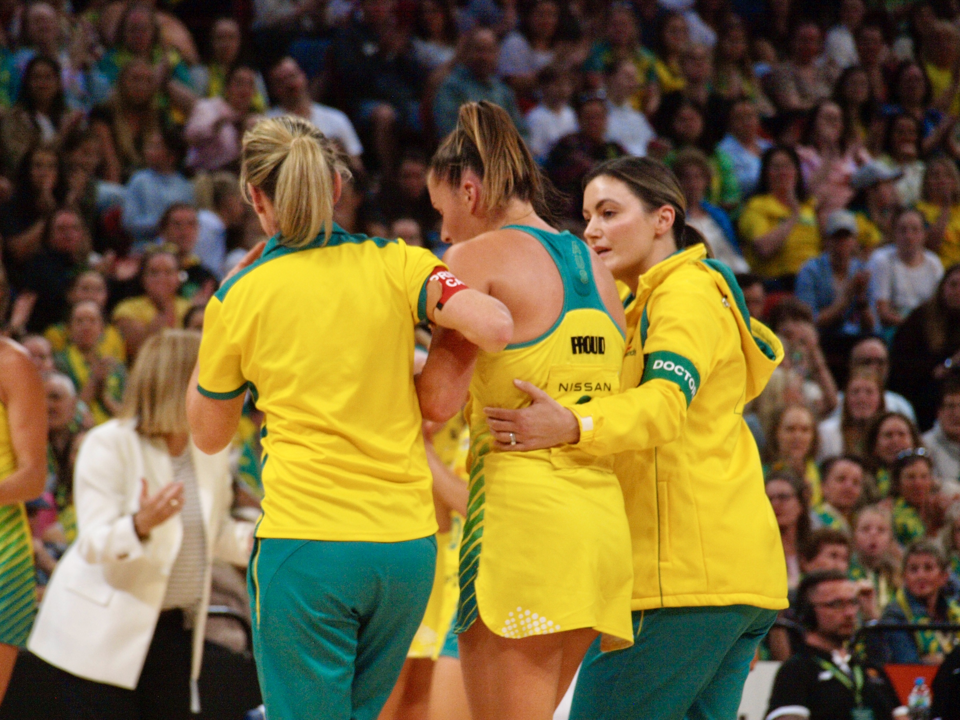 Maddy Proud was helped from the court after a collision with Kiera Austin left her concussed.