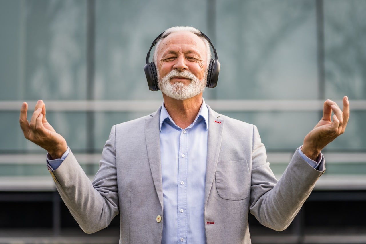 Older man meditating with headphones