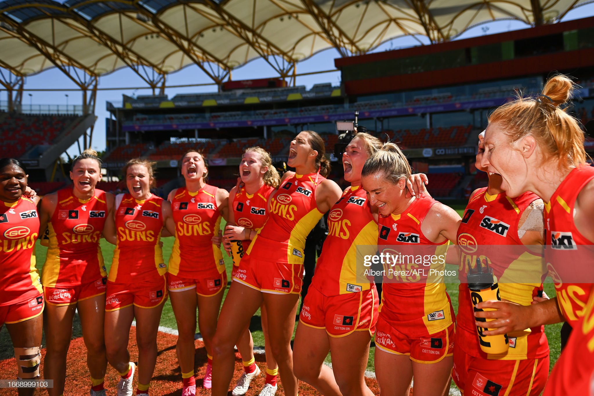 GOLD COAST, AUSTRALIA - SEPTEMBER 09: Suns sing the club song after their victory during the round two AFLW match between Gold Coast Suns and West Coast Eagles at Heritage Bank Stadium, on September 09, 2023, in Gold Coast, Australia. (Photo by Albert Perez/AFL Photos via Getty Images)