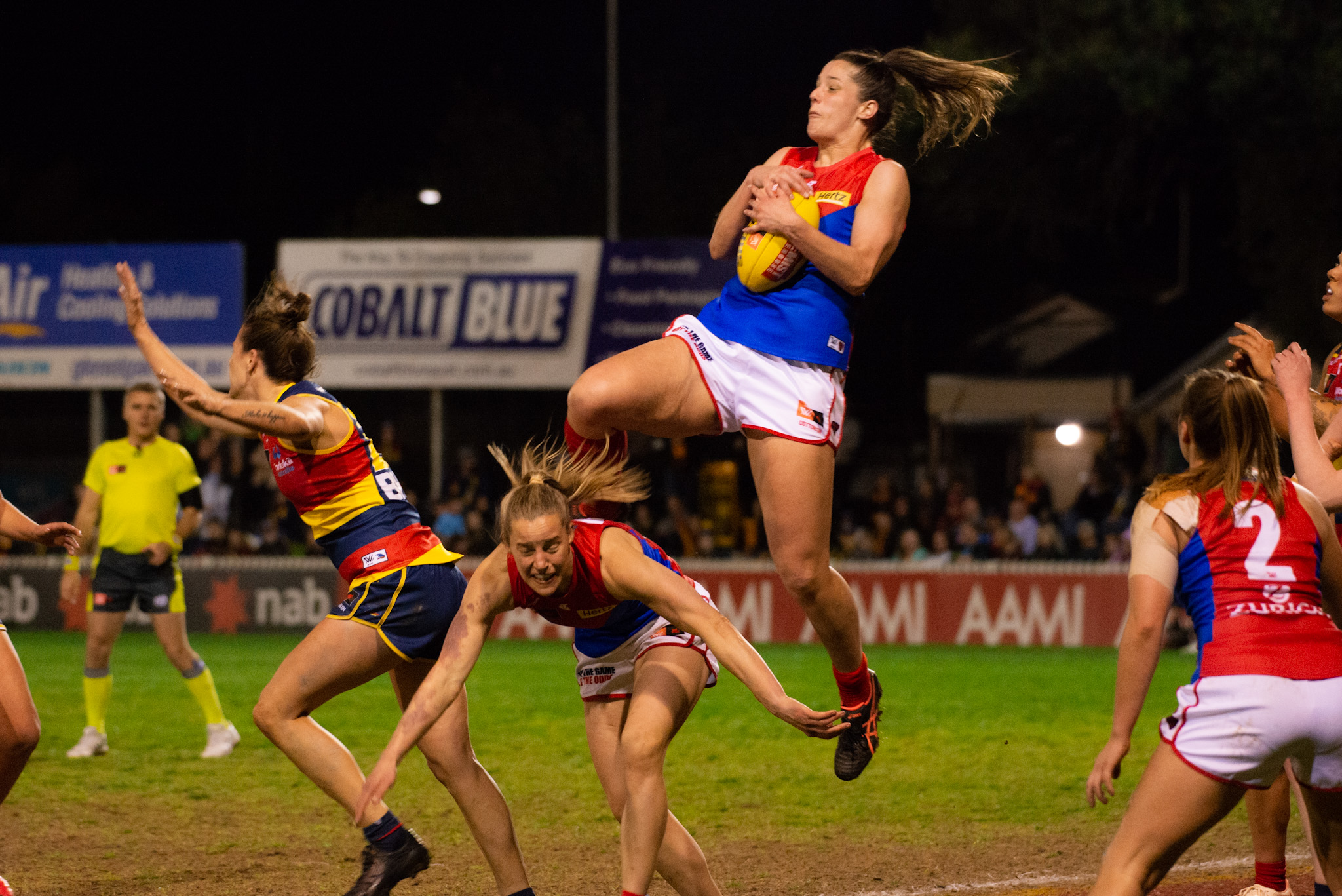 Maddi Gay flies for a mark for the Demons in Round One of Season Seven. Image: Dani Brown