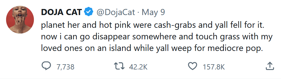 A tweet from Doja Cat on May 9, 2023 reading: "planet her and hot pink were cash-grabs and yall fell for it. now i can go disappear somewhere and touch grass with my loved ones on an island while yall weep for mediocre pop."